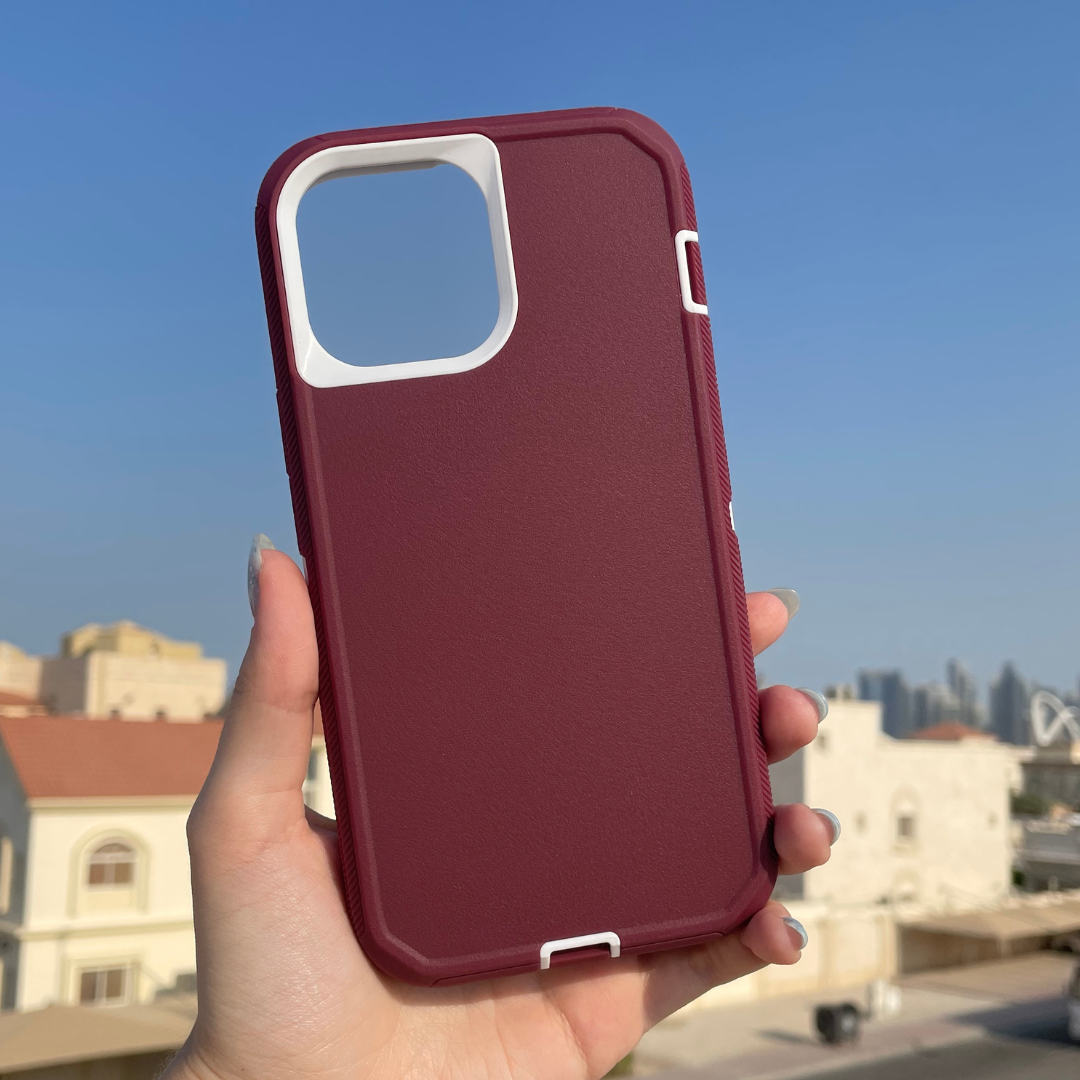 hand holding iPhone protective case maroon and white color