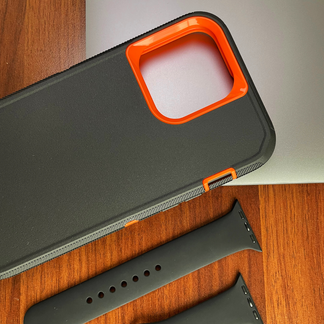 iPhone protective case Black orange on the table near black silicone watchband
